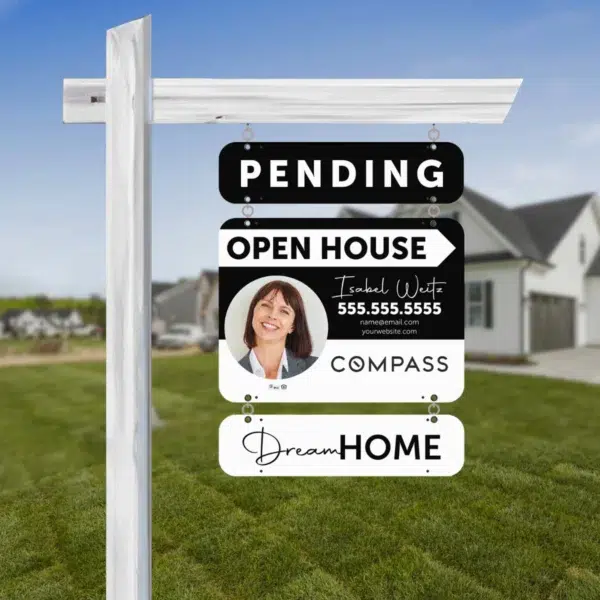 A horizontal real estate sign for Compass brokerage, with sign riders.