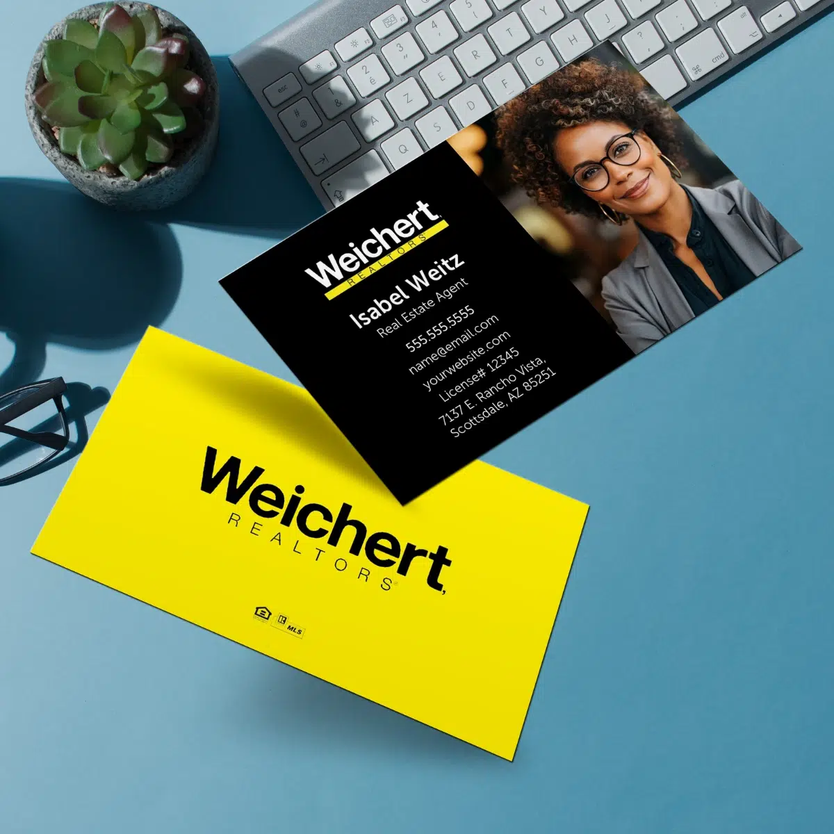 Horizontal Weichert business card with a blue office themed background.
