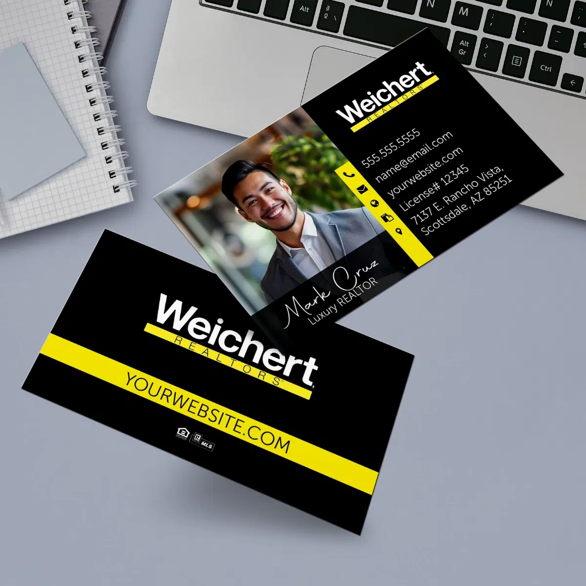 Horizontal Weichert business card with a laptop and note book background.
